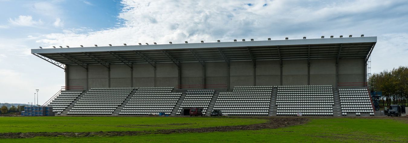 Grandstand overlooking the training pitches at Proximus Basecamp, illuminated by Lumosa LED sports lighting.